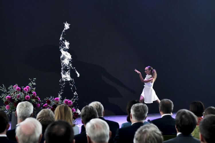 Tänzerin auf Bühne tanzt mit Ai artificial intelligence